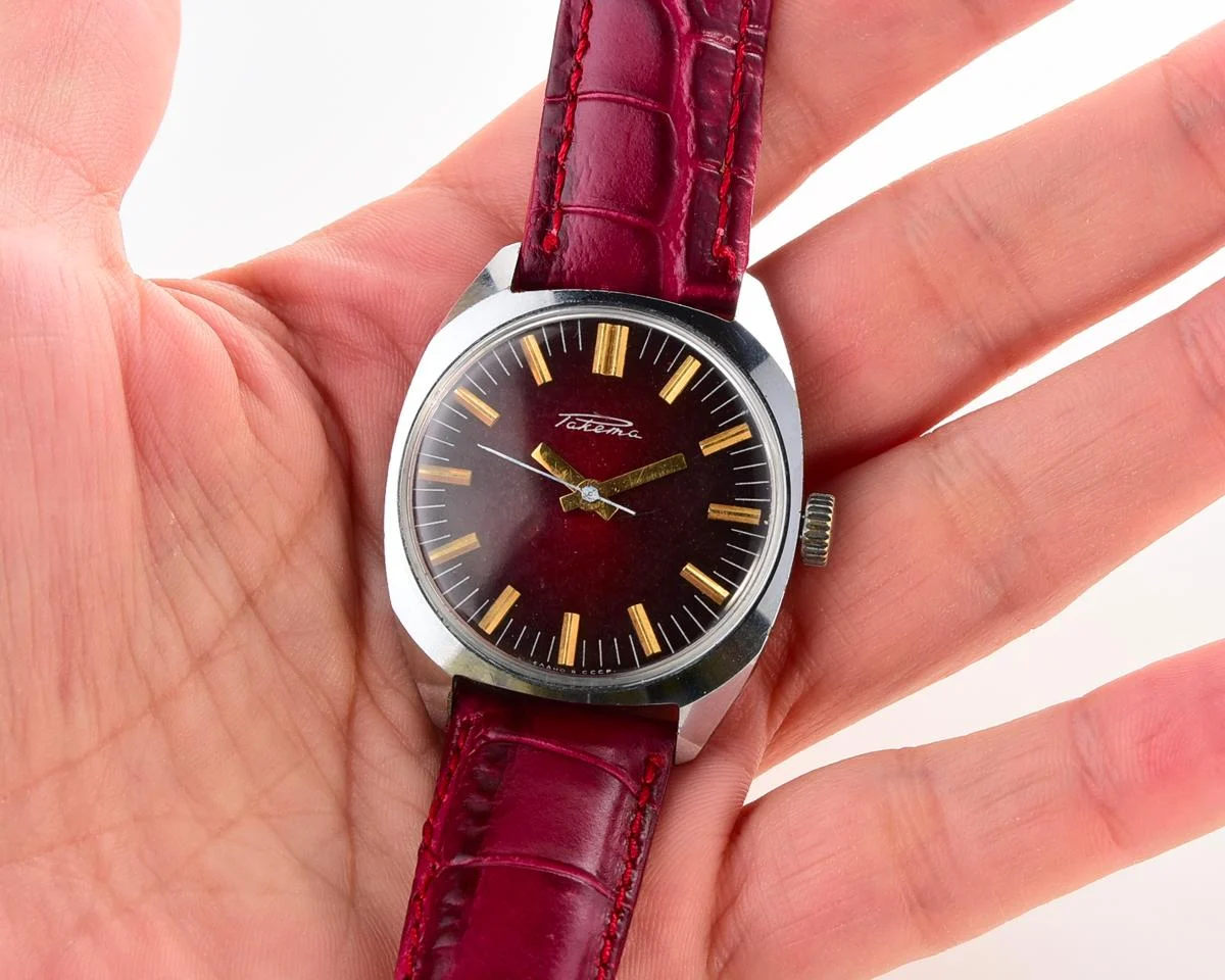 Vintage Soviet Raketa mechanical watch with stark crimson dial