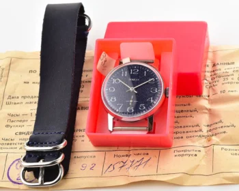 Mechanical wristwatch in original box with extra strap and vintage paperwork, new old stock display.