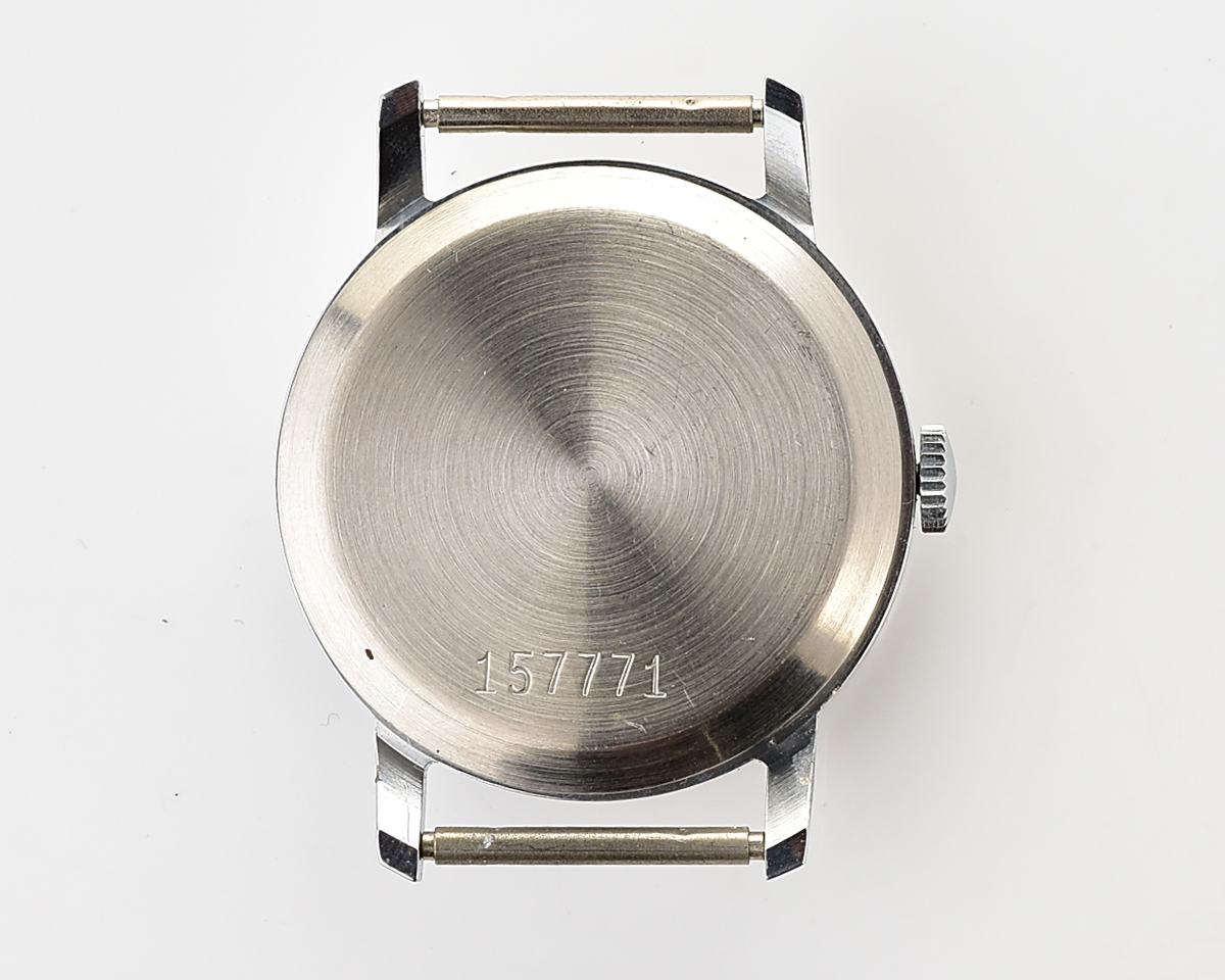 Back view of a vintage mechanical wristwatch case with serial number, displayed for sale on product page.