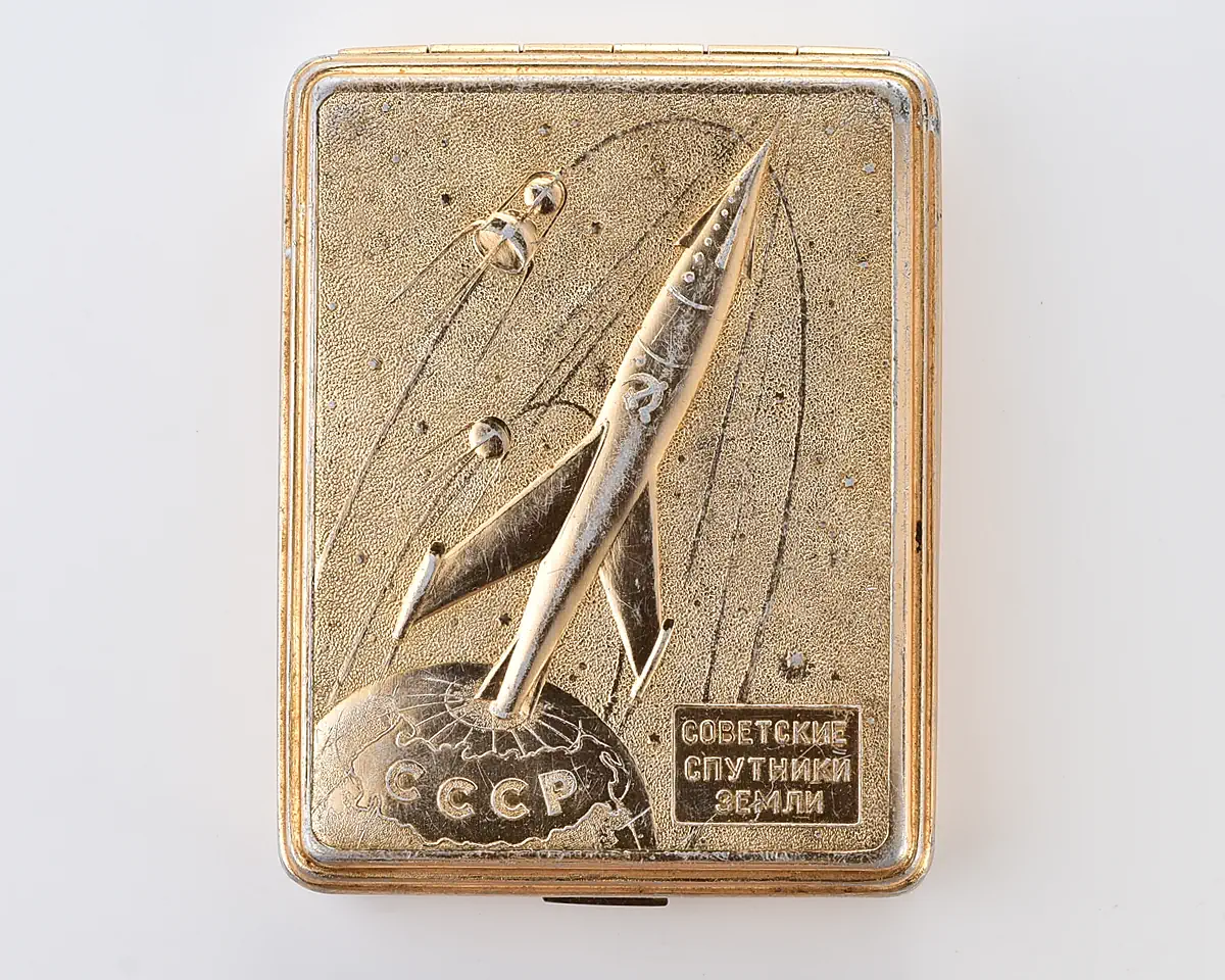 Vintage Space Rocket Sputnik metal cigarette box – "Soviet Earth Satellites", gold-tone Soviet cosmos exploration era relic