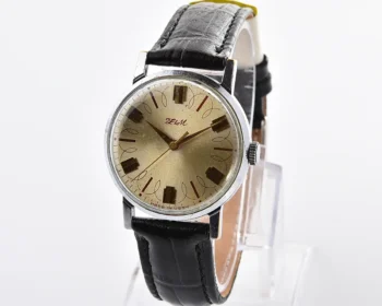 Vintage Soviet ZiM mechanical watch – champagne sunburst dial with scroll pattern and stepped gilt markers, from the 1970s-80s